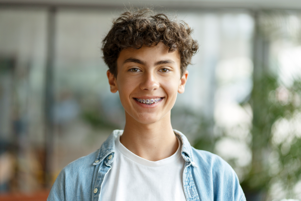 School boy with braces smiling