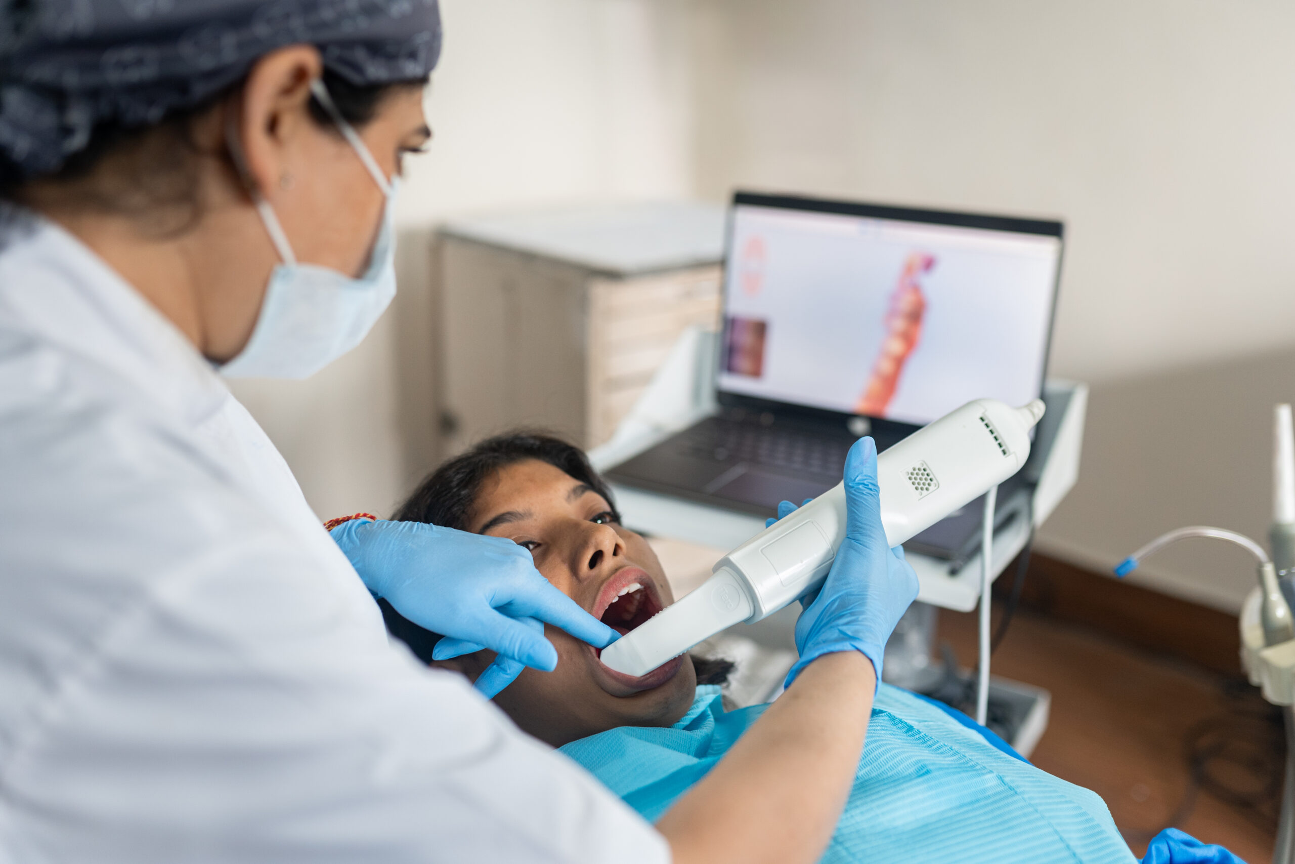 A photo of an orthodontist using an iTero scanner